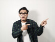 © ARIF MIFTAHUL ANWAR - Adult Asian man showing shocked expression with both hands pointing to the left side