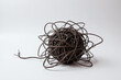 © Sweeann - A tangled ball of wires, knotted cables. Concept on chaos, complex problem, mental confusion, awry plans, complicated relationship, life challenges and interconnection. White background, isolated.