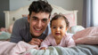 © Tom - A joyful young Caucasian man and his adorable baby girl play together in a cozy bedroom, capturing a heartwarming moment full of love and laughter.