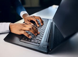Aufkleber - Close-up of hands typing on a dark laptop keyboard.  The scene is dimly lit, suggesting a late-night work session.