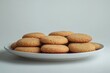 © Tatyana - A plate of freshly baked snickerdoodle cookies with cinnamon sugar coating.