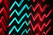 © wolfhound911 - A neon background featuring sharp zigzagging lines in electric red and teal, glowing against a deep black backdrop.