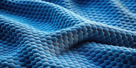 Poster - A textured blue fabric with a hexagonal pattern, resembling a honeycomb structure, creates a visually appealing abstract background.