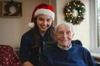 © JuLady_studio - Young female nurse celebrating holidays with elderly caucasian male patient