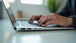 © stockphoto02 - Close up of hands typing on a laptop keyboard  a common scene in modern work life.
