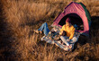 © Zoran Zeremski - Two women camping at top of the hill sitting in front of the tent resting after hiking.