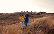 © Zoran Zeremski - Two smiling woman hiking at top of the hill at meadow.