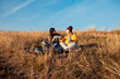 © Zoran Zeremski - Two woman sitting at top of the hill at meadow resting after hiking.