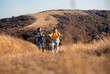 © Zoran Zeremski - Two smiling woman hiking at top of the hill at meadow.