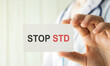 © Pawel - Doctor holding a card with text STOP STD medical concept