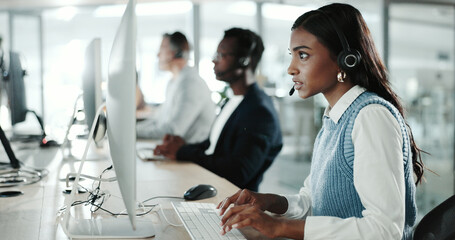 Leinwandbilder - Call center, computer and typing with Indian woman in support office for customer service. Contact us, feedback and research with person speaking on headset in workplace for advice or virtual help