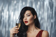 © Buyanskyy Production - Brunette woman in a red dress holding a champagne glass with a relaxed and slightly tipsy expression, set against a glittering silver backdrop. Great for lifestyle, party, or festive themes.