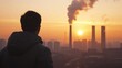 © Zoro - Man silhouetted against sunrise with industrial pollution.