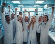 © Titon - A group of happy doctors celebrating in the laboratory, wearing white coats and glasses, raising their arms with fists raised high