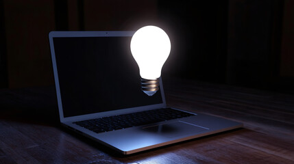 Aufkleber - Light bulb illuminating laptop on wooden table in dark room symbolizing new ideas, innovation, and creativity