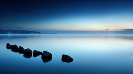 Wall Mural - A body of water with a few rocks in it