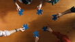 © Summit Art Creations - Top down view of skilled business people separated blue jigsaw puzzle on meeting table. Group of diverse team working together to solve the puzzle. Represented togetherness, cooperative. Convocation.