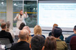 © Anton Gvozdikov - Speaker leads corporate presentation in meeting room. Engaged audience focuses on learning and discussions.