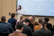 © Anton Gvozdikov - Focused participants listening to speaker in conference room with projector screen. Educational and professional environment.