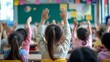 © DYAH - Children raise hands in classroom, eager to participate in lesson.