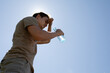 © kieferpix - man drinking water feeling exhausted in the heat of the day