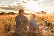 © kieferpix - Father son, parent child enjoying family time relaxing in the park