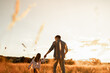 © kieferpix - Happy family, Father little child daughter at sunset.  family fun. Parent, dad daughter holding hands play together bonding in nature meadow field