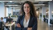 © Bozena - Confident Businesswoman in Modern Office Environment. A confident young woman with curly hair stands in a contemporary office, embodying professionalism and teamwork. Ideal for business-rela...