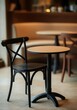 © Carlos - A black chair is sitting next to a round table