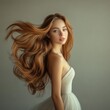© Serhii - Captivating Hairstory: Stunning Young Woman with Flowing Wavy Hair Posing Elegantly in Studio