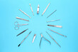 © New Africa - Set of pedicure tools on light blue background, flat lay
