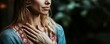 © Александр Михайлюк - Woman taking deep breath with hand on chest, symptom of anxiety, mental health awareness, calming background