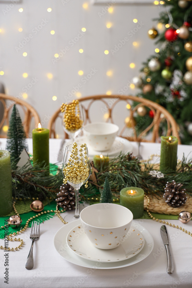 Christmas table setting with burning candles in room, closeup