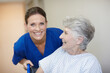 © peopleimages.com - Happy, nurse and senior woman in hospital, smile and healthcare for recovery, assisted living and joy. Sick, retirement and elderly person with disability, caregiver and help for patient in clinic