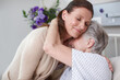 © peopleimages.com - Elderly mom, daughter and hug in hospital bed for support, love or medical health with family. Console, people or embrace for senior care, warm comfort or cancer treatment for sick patient in clinic