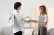 © Pixel-Shot - Female psychologist with teenage boy shaking hands in office
