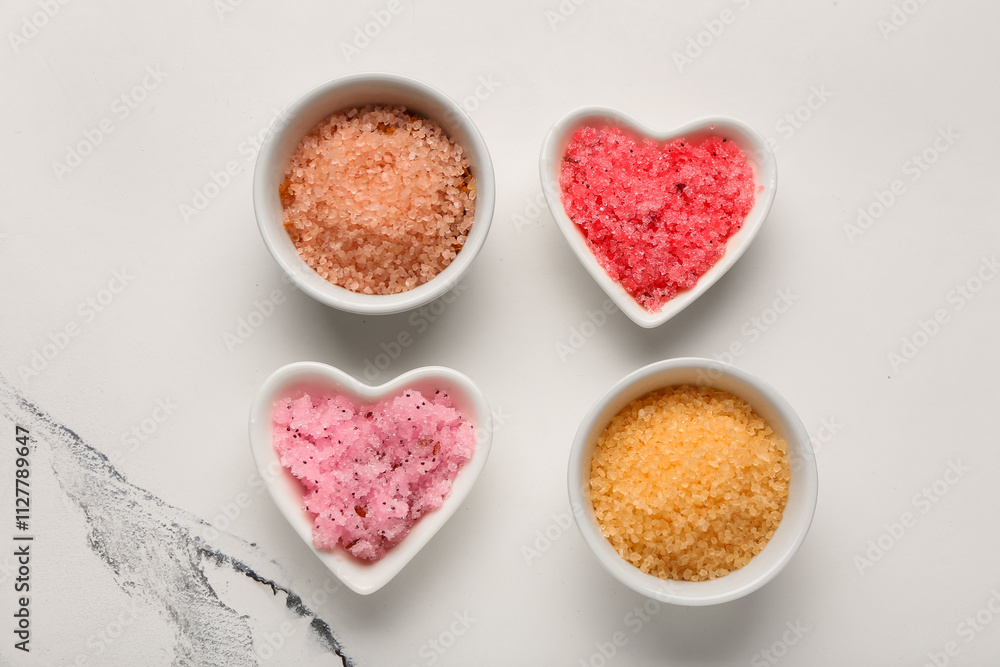 Bowls with scrubs on light background