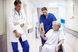 © peopleimages.com - Healthcare, talking and senior woman with doctor, hospital and explaining of diagnosis and retirement. Clinic, medical professional and conversation with person with disability, wheelchair and nurse