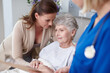 © peopleimages.com - Elderly mother, daughter and nurse in hospital for medical exam, consultation or doctors appointment. Female people, senior care and support in clinic for visit, healthcare services or cancer patient