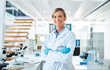 © peopleimages.com - Mature woman, scientist and ppe in portrait for medical research, innovation and phd in science lab. Female person, happiness and confidence in pharmaceutical, chemistry and biotech with arms crossed