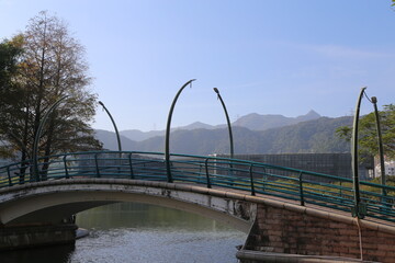 Wall Mural - A bridge over a river with a mountain in the background