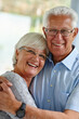 © peopleimages.com - Hug, portrait and senior couple in house with love, care and happy marriage in retirement together. Embrace, elderly man and old woman in home with smile, support and comfort with morning bonding.