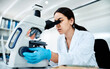 © peopleimages.com - Woman, scientist and microscope at laboratory for medical research or investigation on virus. Female person, science and serious with healthcare study for pathology, bacteria and test sample