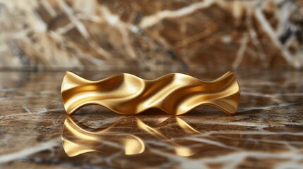 Abstract gold wave shaped object on marble.