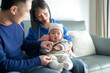 © Masakazu Tokashiki - A 6-month-old boy spends time on a couch with his mother and father from a Chinese family on a cold winter day in an apartment building in the Pudong New Area of ​​Shanghai, China.