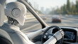 © Tossakan Photos - A humanoid robot sits in the driver's seat of a car.