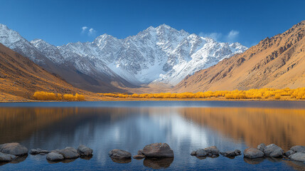 Wall Mural - Majestic winter landscape of snow-covered mountains reflected in a tranquil lake surrounded by frosty trees serene atmosphere evoking peace solitude natural beauty and the timeless power of nature