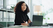© Clement/peopleimages.com - Laptop, thinking and woman in office with ideas, smile and budget solution at accounting agency. Consultant, accountant or businesswoman at desk with financial planning for online business report