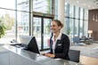 © NISHAN'S STUDIO - Smiling receptionist welcoming visitors at a modern company lobby