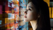 © Papisut - Contemplative woman gazing at illuminated data screens in a tech environment, reflecting on future possibilities and digital insights